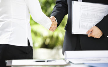 Handshake between businessman and businesswoman in a meeting